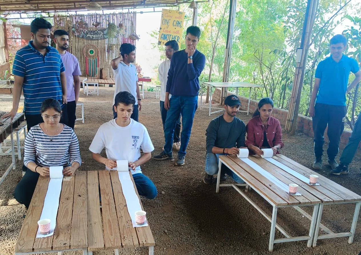 Colleagues racing to unroll paper along wooden benches in a team game